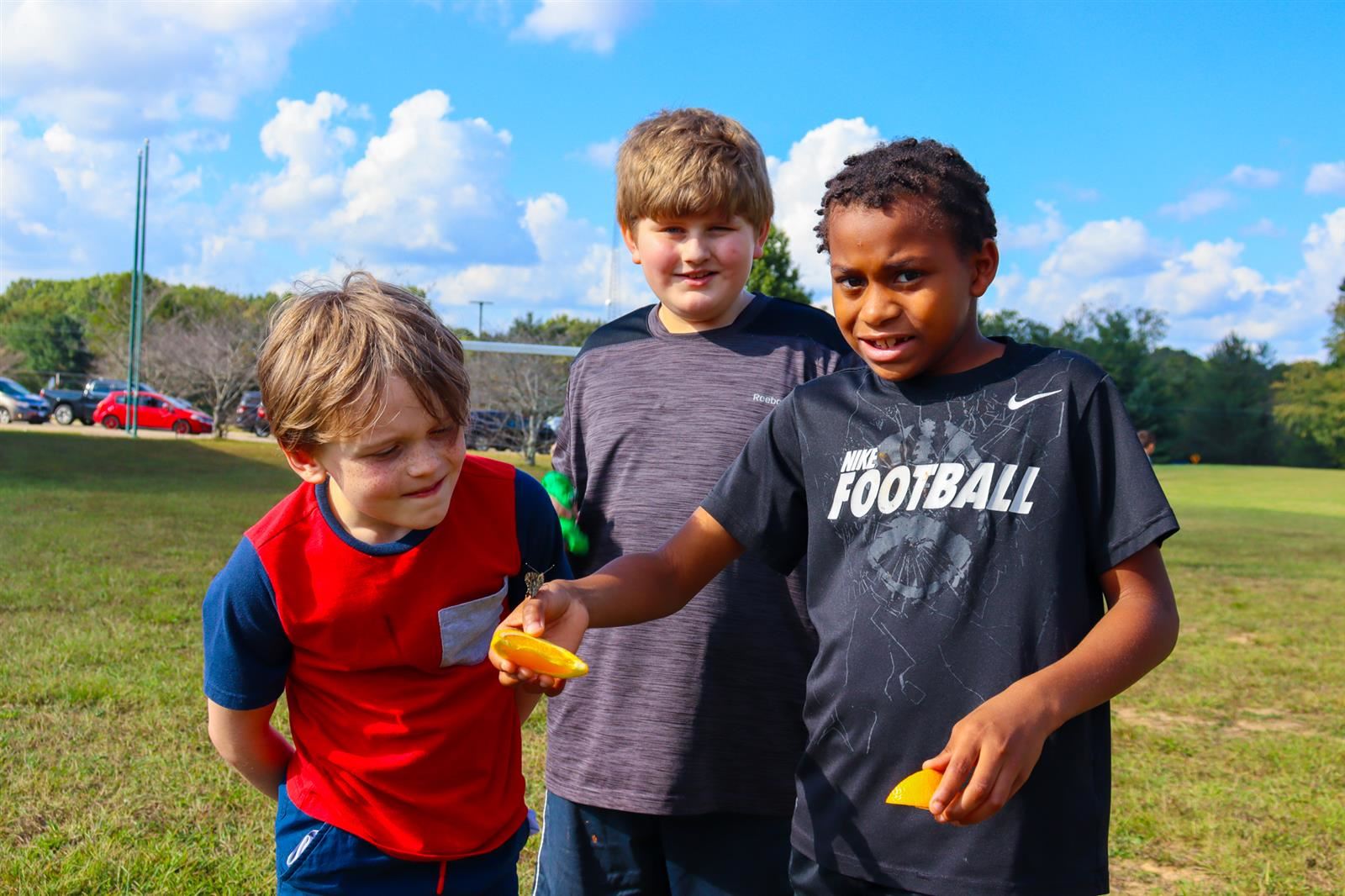 three boys with butterflies